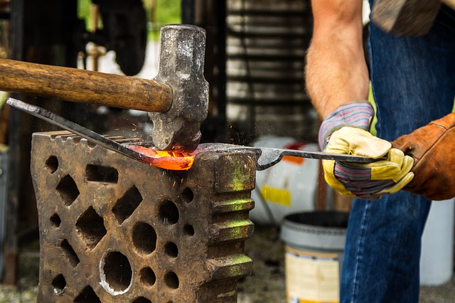 Hammering iron on an anvil